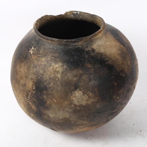 169 - A large African pottery cooking pot, height 20cm