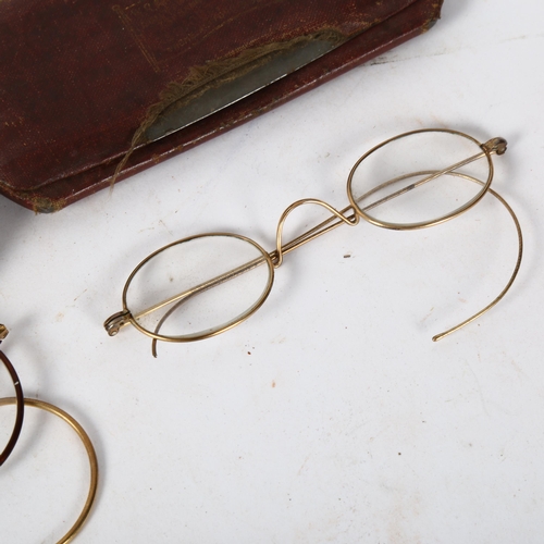 184 - A pair of early 20th century tortoiseshell and 10ct gold glasses, and another, both cased (2)