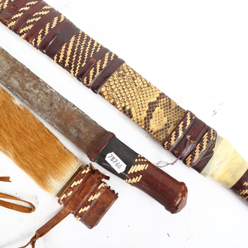 208 - 2 African short swords, with woven leather and hide scabbards, longest 67cm