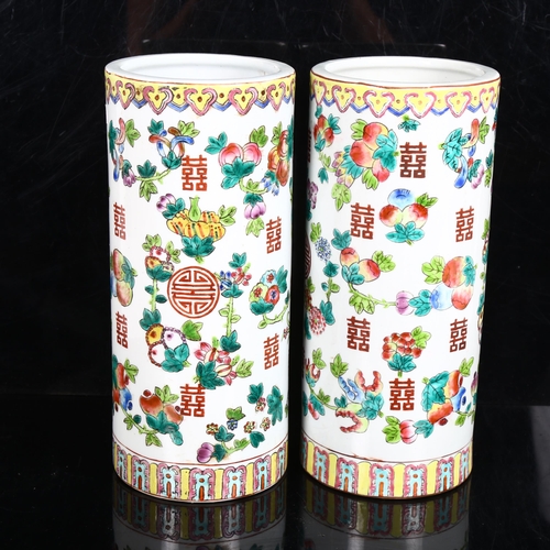217 - A pair of Chinese famille verte fruit cylinder vases, marks on bases, height 28cm