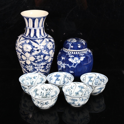 226 - A Chinese blue and white prunus decorated ginger jar and cover, blue and white baluster vase, and a ... 