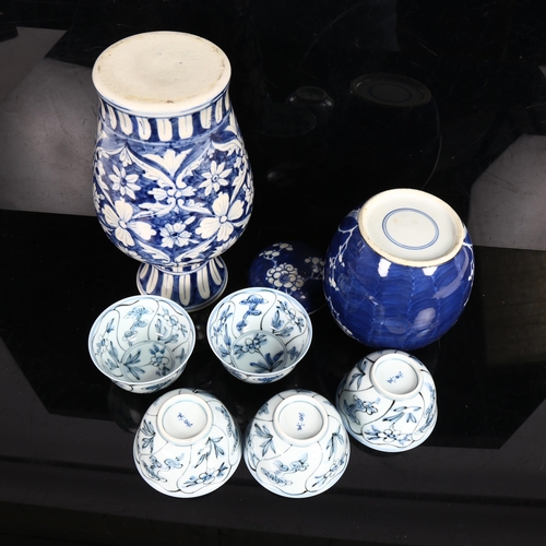 226 - A Chinese blue and white prunus decorated ginger jar and cover, blue and white baluster vase, and a ... 