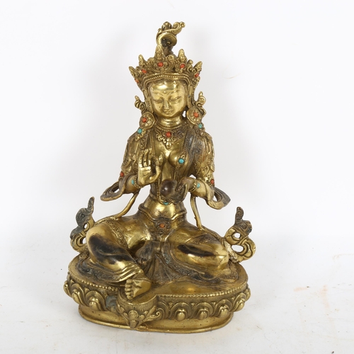 239 - A polished bronze stone set seated Buddha, on lotus base, height 22cm