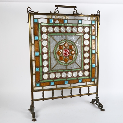 25 - A brass-framed stained-glass fire screen, height 78cm, width 55cm (A/F)