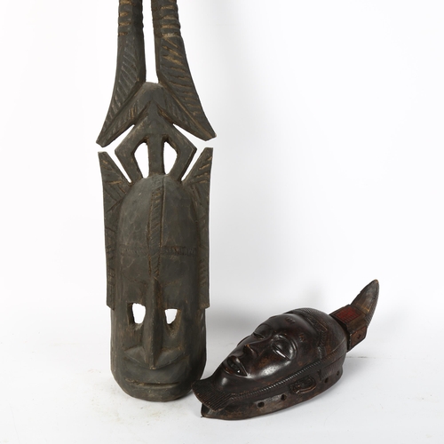 63 - African Dogon Tribal carved wood mask, height 37cm, and another African carved wood horned mask, len... 