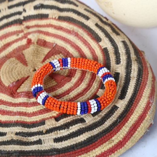 66 - Various African Tribal items, including basketweave cowrie shell lid, beadwork collar necklace, ostr... 