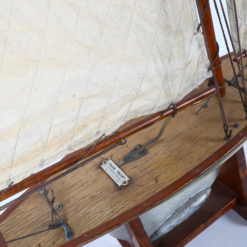 69 - A Vintage wooden-hulled model pond yacht, by Ailsa Yachts of Scotland, hull length 47cm, overall hei... 