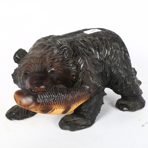 78 - A Hokkaido style ebonised pine bear sculpture, length 32cm