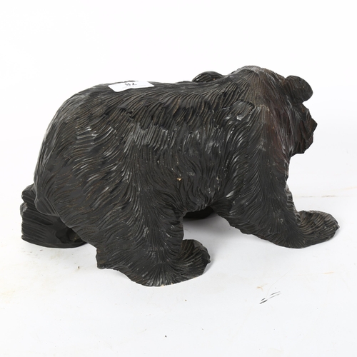 78 - A Hokkaido style ebonised pine bear sculpture, length 32cm