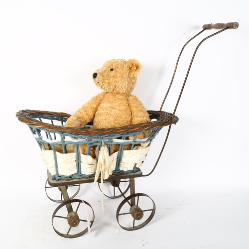 92 - A Steiff teddy bear, and a wicker teddy bear/doll's pram