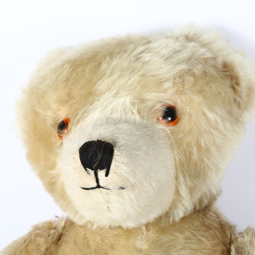 95 - A large Vintage straw-filled teddy bear, height 80cm