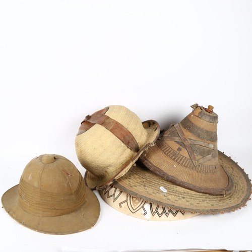 65 - A Victorian British Army khaki pith helmet, and various African basketweave hats