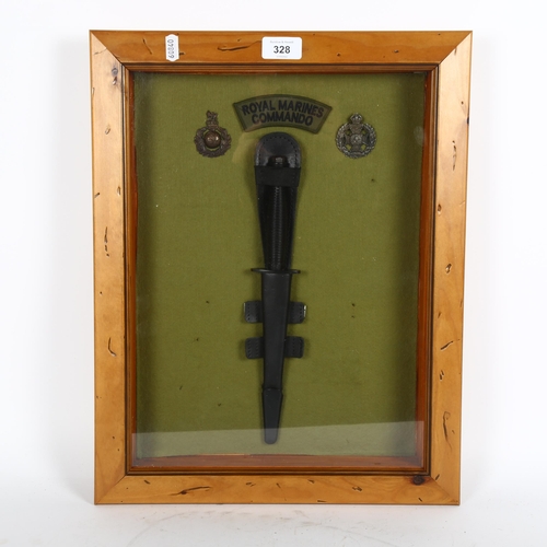 328 - A Royal Marines Commando knife, and 2 badges, in glazed frame, height 47cm