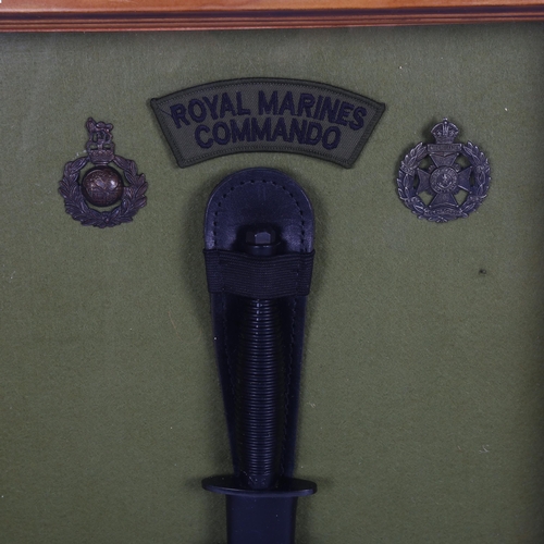 328 - A Royal Marines Commando knife, and 2 badges, in glazed frame, height 47cm