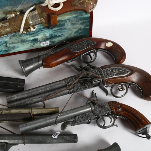 352 - Reproduction pistols, an Eastern knife with embossed metal scabbard and wall plaque