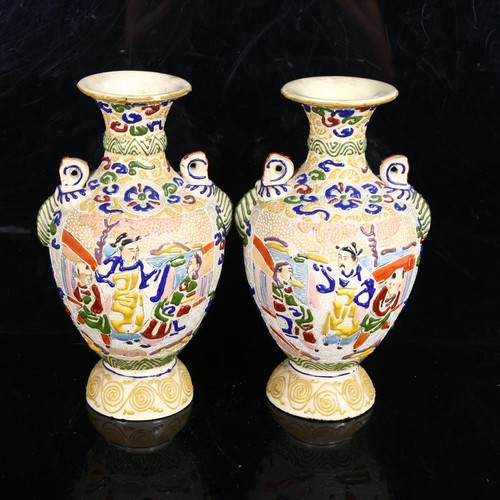 228 - A pair of Japanese Satsuma vases, with embossed enamelled decoration, height 22cm