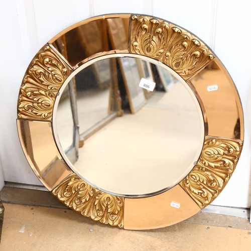 806 - An Art Deco circular wall mirror, with peach glass and embossed gilt frame, height 60cm