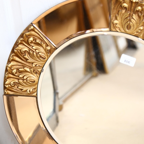 806 - An Art Deco circular wall mirror, with peach glass and embossed gilt frame, height 60cm