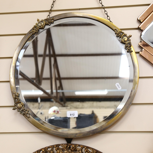 812 - A Vintage bevel-edge circular wall mirror, in silver plated frame with applied motifs, 38cm