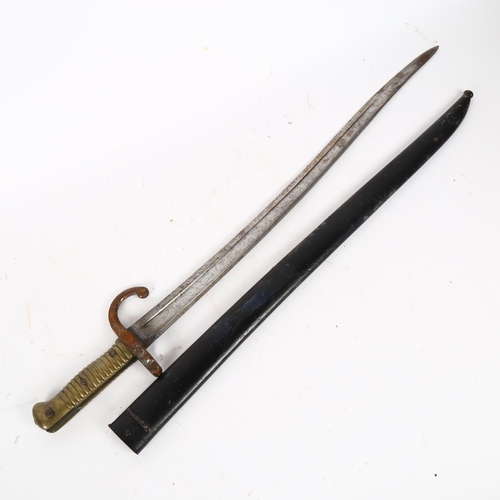 819 - Antique bayonet in scabbard, with turned brass handle, 70cm