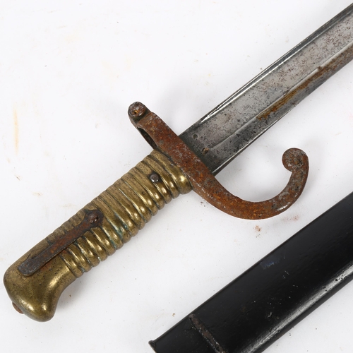 819 - Antique bayonet in scabbard, with turned brass handle, 70cm