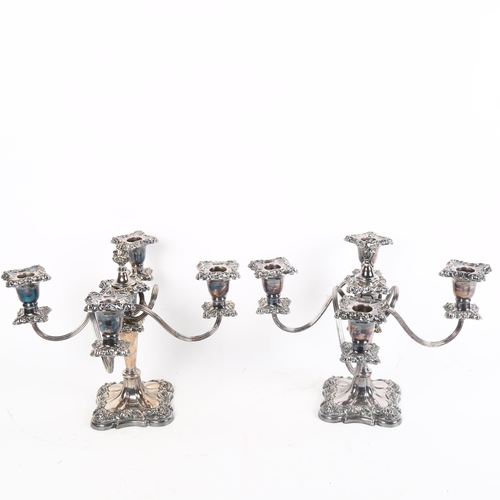 1000 - A pair of silver plate on copper 4-branch table candelabras, with embossed decoration, height 26cm