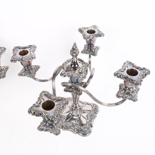 1000 - A pair of silver plate on copper 4-branch table candelabras, with embossed decoration, height 26cm