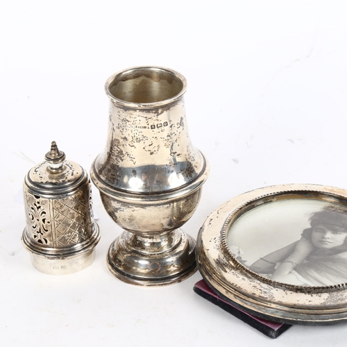 1004 - A George V silver sugar caster, Birmingham 1915, and a circular silver-fronted photo frame (2)