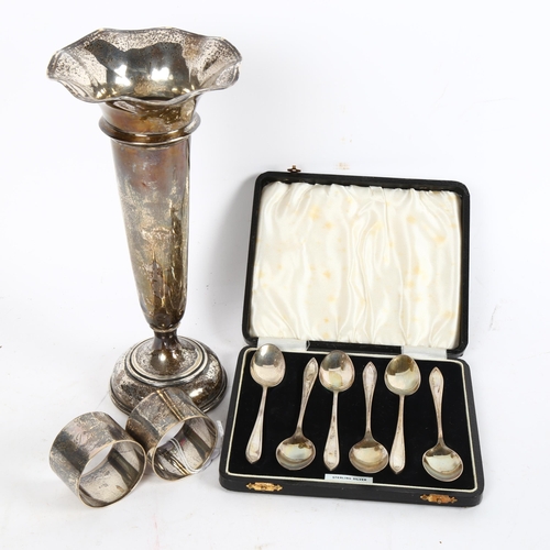 1005 - A silver trumpet bud vase, height 23cm, a pair of silver napkin rings, and a cased set of 6 silver t... 