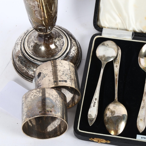 1005 - A silver trumpet bud vase, height 23cm, a pair of silver napkin rings, and a cased set of 6 silver t... 