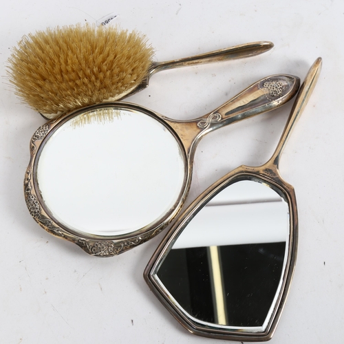 1011 - An engine turned silver-backed dressing table mirror and matching brush, and an Art Nouveau silver-b... 