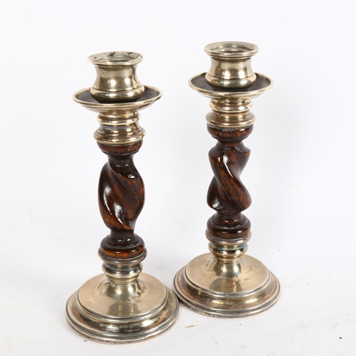 1016 - A pair of George V silver-mounted candlesticks, with oak barley twist columns, height 17cm, hallmark... 