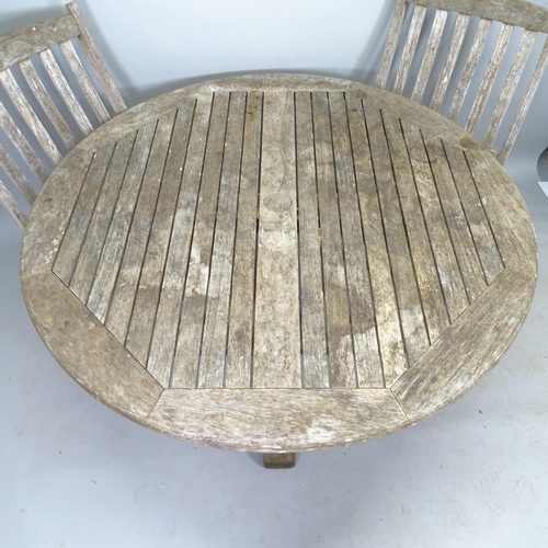 2527 - A weathered teak circular-topped garden table, with 5 matching chairs, with label for F. Peart & Com... 