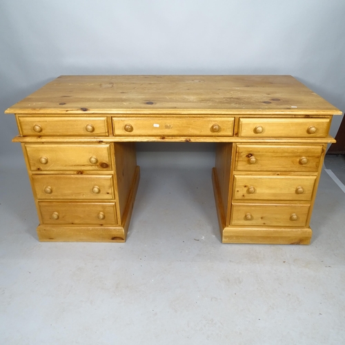 2542 - A modern pine twin-pedestal writing desk, with 9 fitted drawers, 154cm x 79cm x 79cm