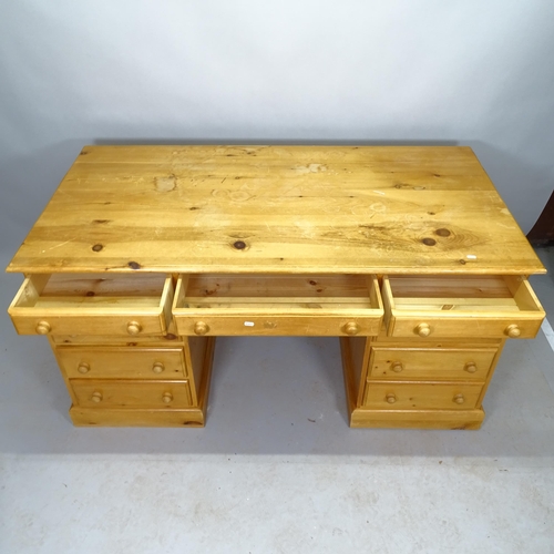 2542 - A modern pine twin-pedestal writing desk, with 9 fitted drawers, 154cm x 79cm x 79cm