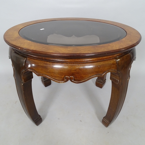 2545 - An Oriental style hardwood oval occasional table, with inset glass top, 69cm x 54cm x 60cm