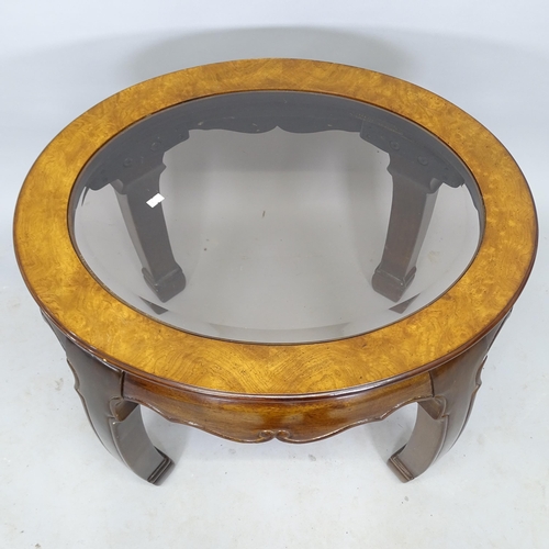 2545 - An Oriental style hardwood oval occasional table, with inset glass top, 69cm x 54cm x 60cm