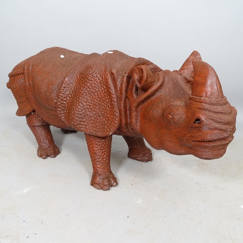 2552 - A carved wooden sculpture of a rhino, L110cm