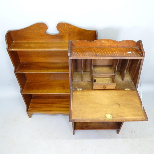 2573 - A 1930s oak student's bureau, 51cm x 107cm x 20cm, and a mahogany waterfall open bookcase, 77cm x 10... 