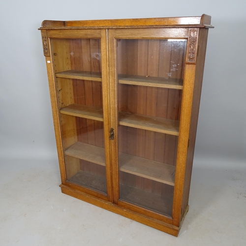 2594 - A 1930s oak 2-door bookcase, with 3 adjustable shelves, 105cm x 135cm x 28cm