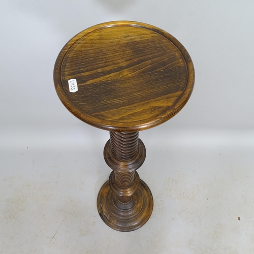 2610 - A stained oak torcher with spiral turned column, H101cm