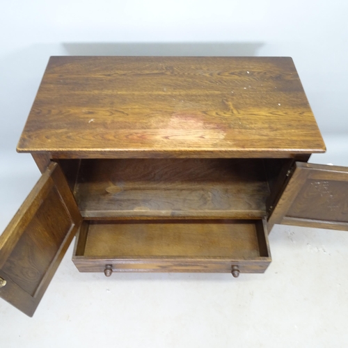 2633 - A 1930s oak hall cabinet, with linenfold panel doors, and single drawer under, 79cm x 85cm x 40cm