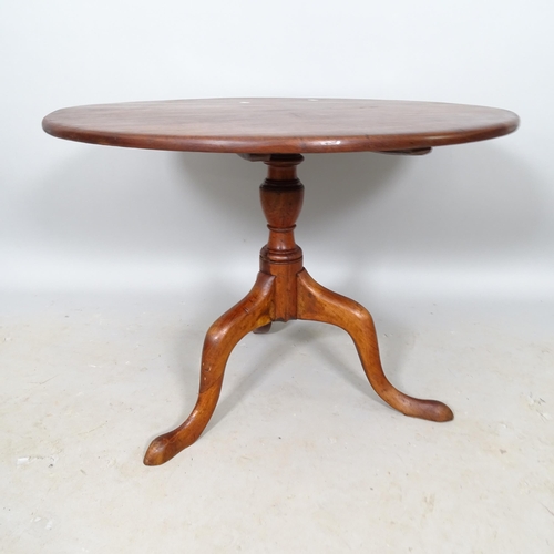 2663 - A Georgian mahogany circular tilt-top occasional table, 75cm x 55cm