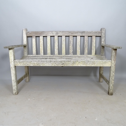 2687 - A weathered teak slatted garden bench, L128cm