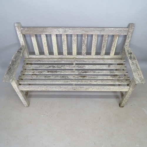 2687 - A weathered teak slatted garden bench, L128cm