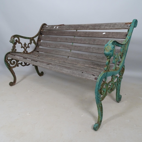 2692 - A weathered teak slatted garden bench with cast-iron ends, L130cm