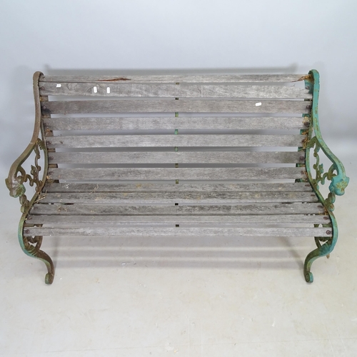 2692 - A weathered teak slatted garden bench with cast-iron ends, L130cm