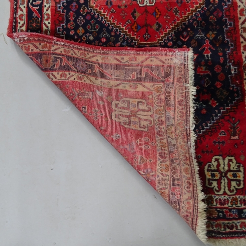 2419 - A red ground Afghan rug, 185cm x 105cm