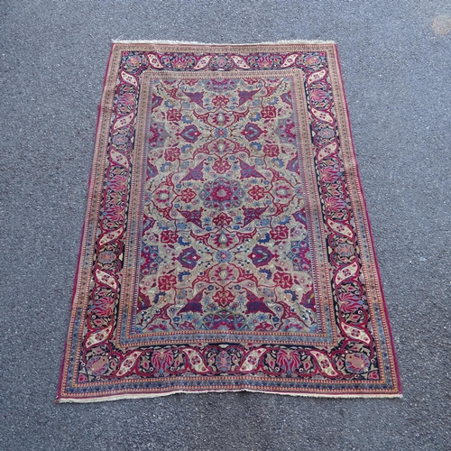 2426 - An Antique red ground Persian Isfahan rug, with repeating border and floral decorated square lozenge... 