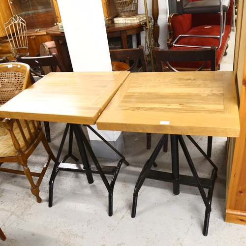 2723 - A pair of modern rise and fall pub tables with metal base, top dimensions 61cm x 56cm